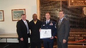 Joining together at the January meeting are (l-r) Col. Pete Farrell, USA (Ret.), General Dynamics; Horace Carney, chapter vice president for education; Senior Master Sgt. Larry Hartman, USAF, recipient of the chapter's Lt. Gen. Douglas D. Buchholz Memorial Scholarship; and Bob Damen, chapter president.